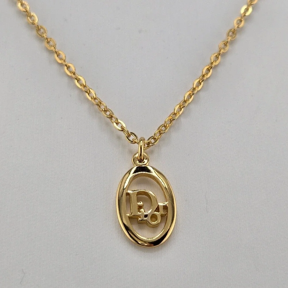 Christian Dior Gold Tone Oval Logo Pendant Necklace Adjustable Chain Vintage